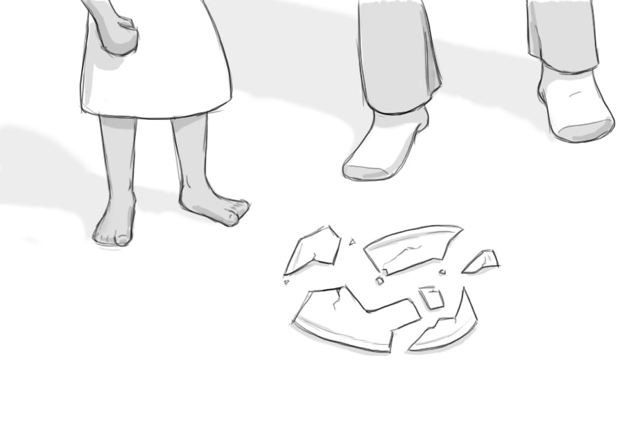 The feet of a child and adult standing at a broken plate.