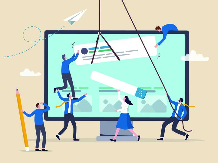 An illustration of six tiny people placing website components on a monitor screen.
