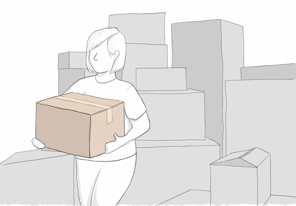 A woman carries a box from a stack of boxes