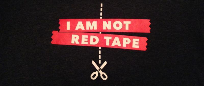 "I Am Not Red Tape" with  a dotted line and scissors down the middle 