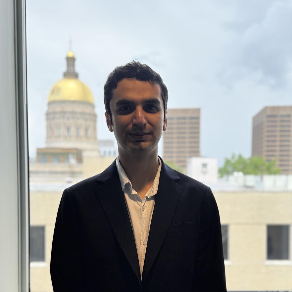 Hadi Rezaei with the golden dome of the Georgia state capitol in the background
